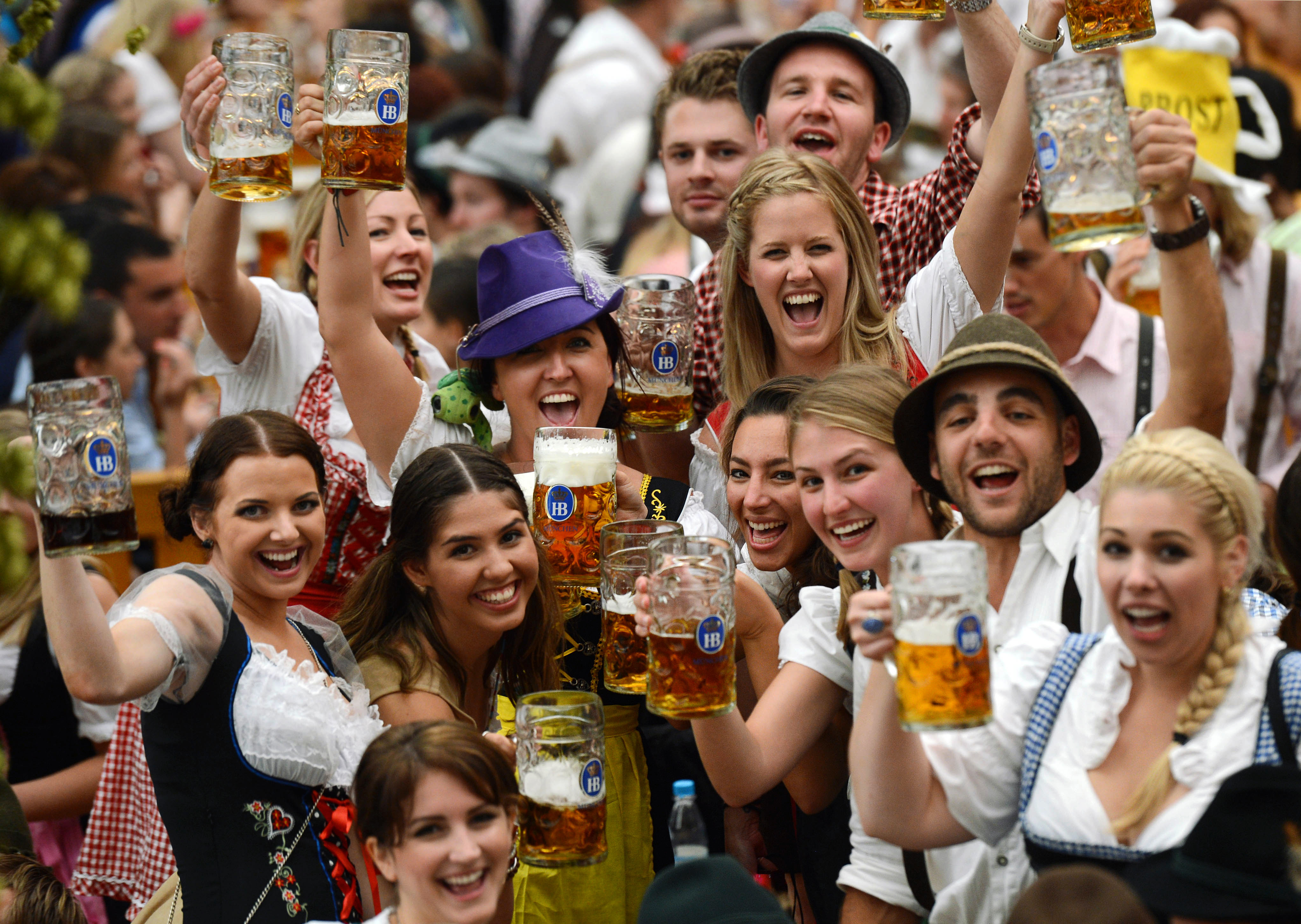 Visitors wearing traditional Bavarian clothes raise their  beers in a festival tent at the start of the Oktoberfest beer festival at the Theresienwiese in Munich, southern Germany. This year's edition of the world's biggest beer festival Oktoberfest will run until October 7, 2012. AFP PHOTO / CHRISTOF STACHE        (Photo credit should read CHRISTOF STACHE/AFP/GettyImages)